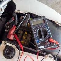 using a multimeter to test CDI box of a motorcycle.